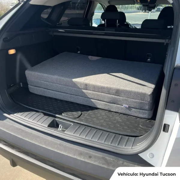 Matelas pour coffre de voiture ou SUV plié proprement dans un Hyundai Tucson, mousse haute densité.